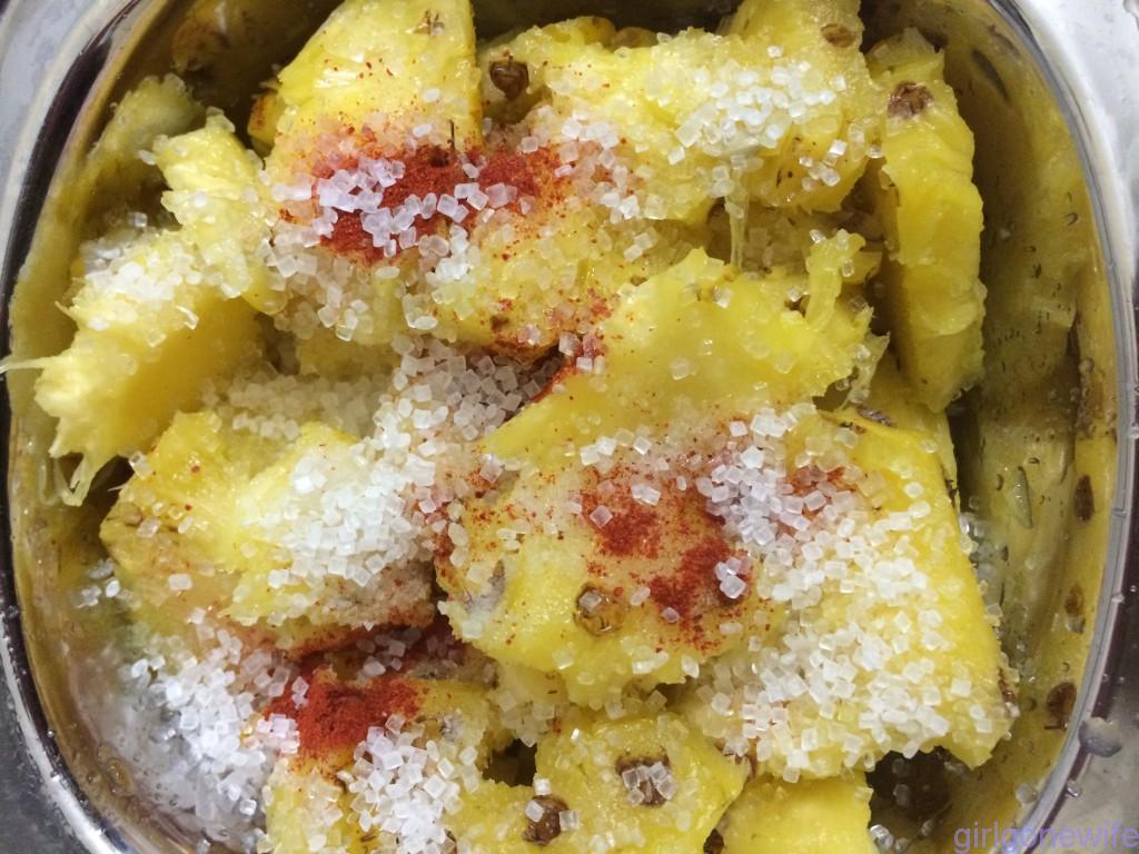 Lemon, salt,sugar, and red chilli powder in pineapple pieces.