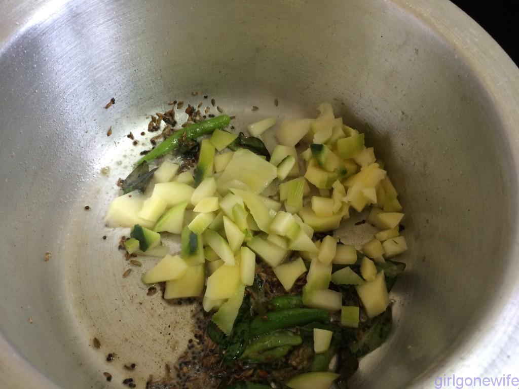Add raw mango pieces and fry till they are cooked